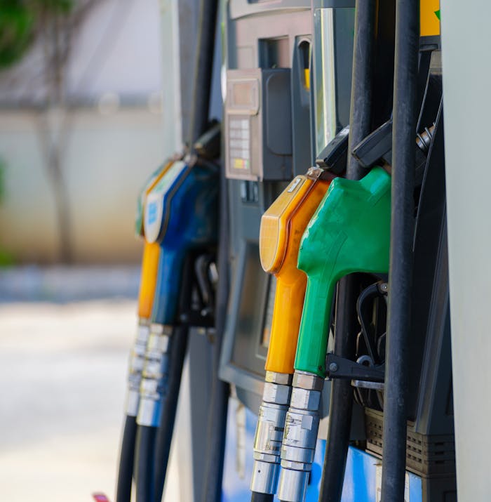 gallery-04 Close-up of vibrant fuel nozzles at a gasoline station showcasing diesel, gas, and petrol options.